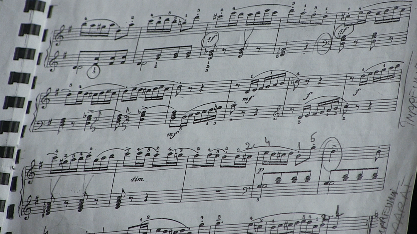An image of sheet music within a book to illustrate tempo and BPM in music.