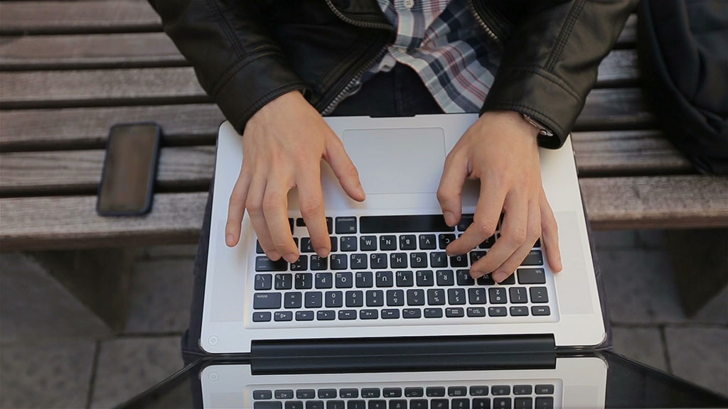 Man Typing on a Mac Laptop
