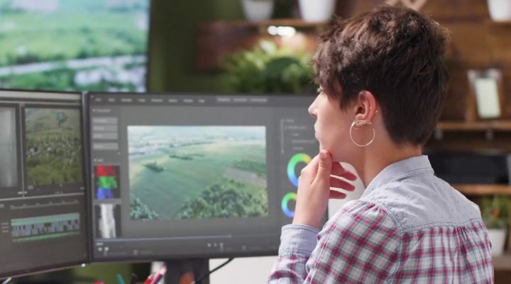 person editing video at desk