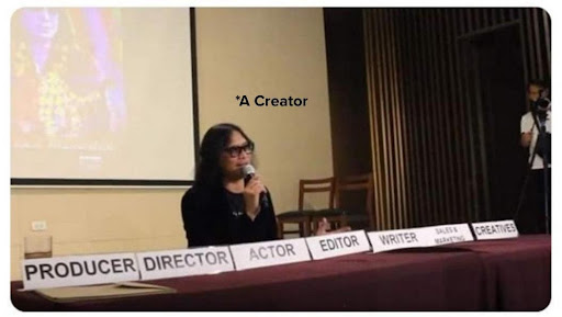 A creator speaking at a conference with multiple job title cards